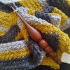 Wooden crochet hook on crochet work in progress