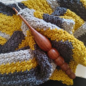 Wooden crochet hook on crochet work in progress