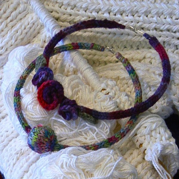 Knit i-cord neck piece embellished with knit and crochet roses